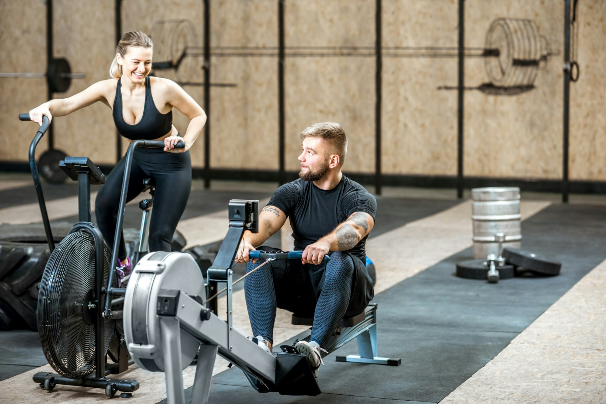 Couple training with exercise machines in the gym